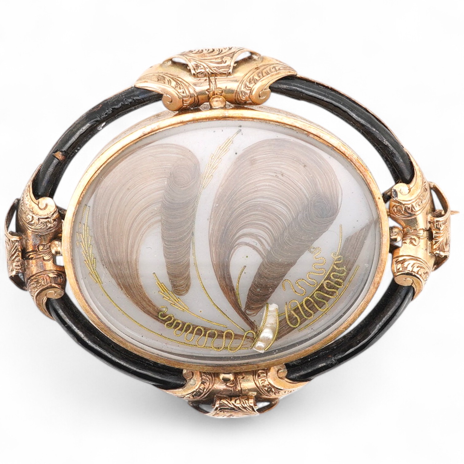 A Victorian yellow metal and black enamel oval mourning brooch, with plaited hair beneath a glazed panel, the back inscribed 'In Memory of Alex Rae died 21st Aug. 1848, A.B.', 53mm.